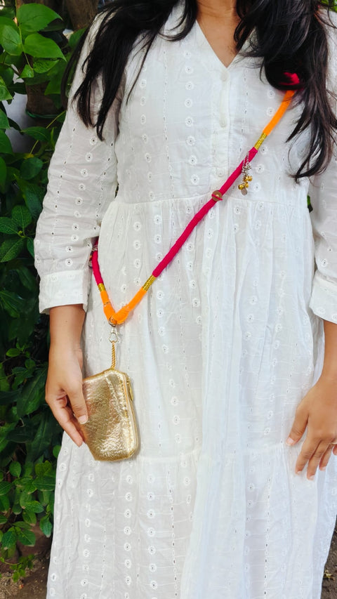 Woman wearing the orange and pink thread-wrapped phone sling