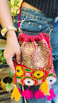 Woman wearing the Kutch Sequence Potli 1